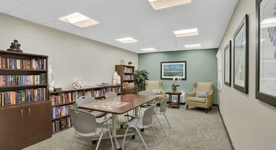 Cozy common area with seating and bookshelves.