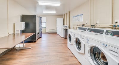 Laundry room with washing machines and dryers