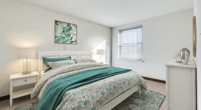 Cozy bedroom with green and blue decor.