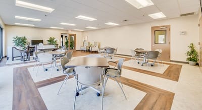 Spacious common area with seating and tables