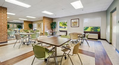 Bright common area with tables and chairs.