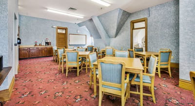 Dining area with tables and chairs in a common room.