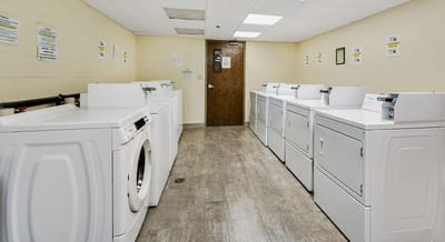 Laundry room with washing machines and dryers