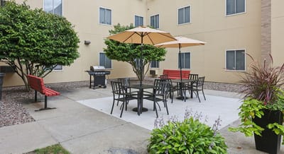 Outdoor seating area with umbrellas and grill