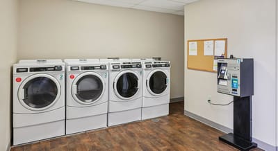 Laundry room with machines and payment station