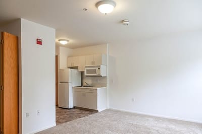 Interior view of a resident's room with kitchen