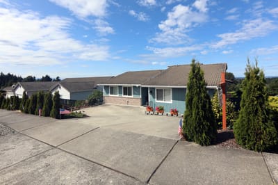 Exterior view of Harbor View Adult Family Home with gardens