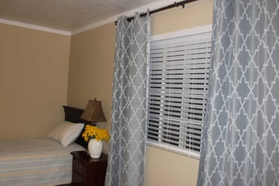 Cozy resident room with bed and curtains