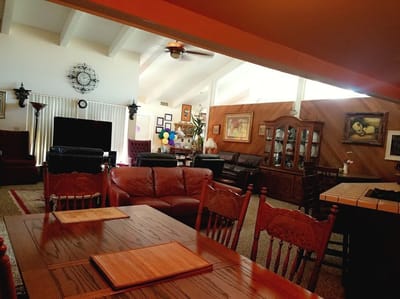 Common area with seating and decor in a senior care facility