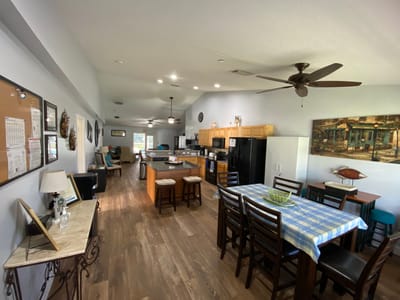 Spacious common area with residents relaxing and dining