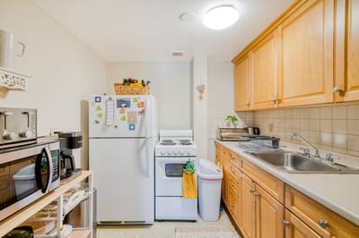 Bright kitchen space with appliances and cabinetry