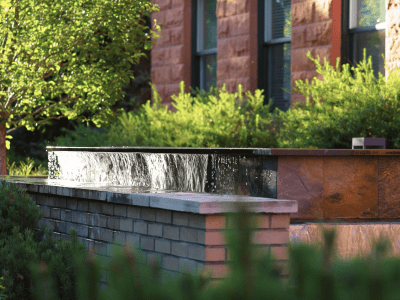 A tranquil outdoor water feature surrounded by greenery