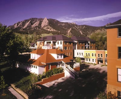 Exterior view of a senior living facility with mountains