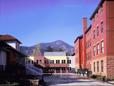Exterior view of a senior living facility with mountain backdrop