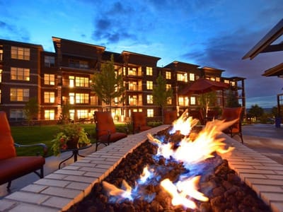 Outdoor fire feature with the facility buildings in the background
