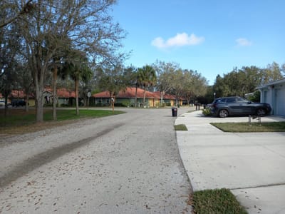A quiet street view of the facility exterior with landscaping