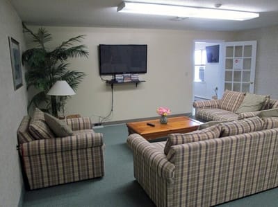 Common area with seating, TV, and plants
