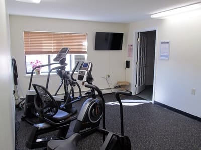 Fitness room with exercise equipment and TV