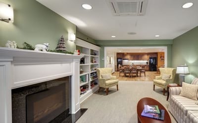 Cozy common area with seating and a kitchen visible