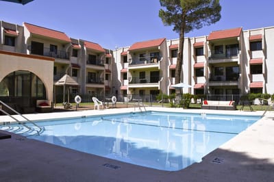 Swimming pool area with residential buildings in the background