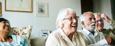 Smiling seniors enjoying each other's company in a common area
