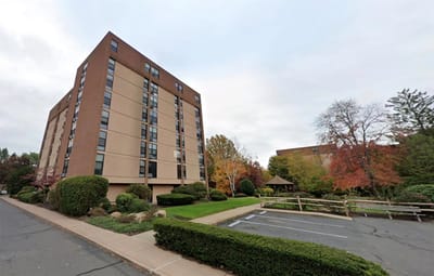 Exterior view of Shepherd Park Elderly Housing surrounded by greenery