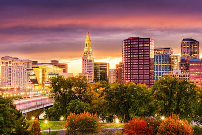 City skyline at sunset with colorful clouds