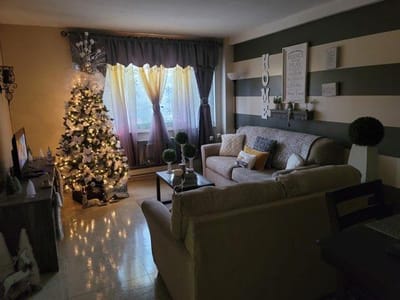 Cozy living room with Christmas tree and decorations