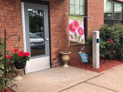 Entrance area with flowers and a welcome sign