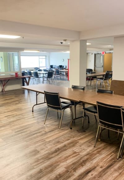Common area with tables and chairs in a bright setting