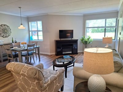 An interior living space with a seating area and dining table