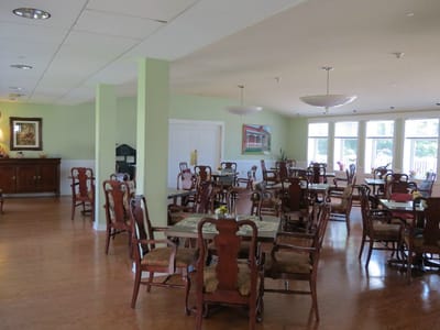 Dining area with tables and chairs in a bright room