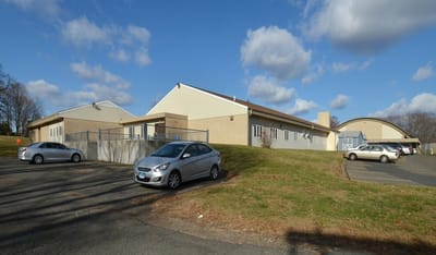 Exterior view of the facility building with parking