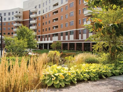 Exterior view of a nursing home facility with gardens