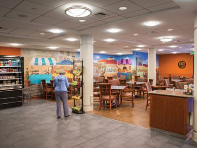 Interior dining area with mural and a resident