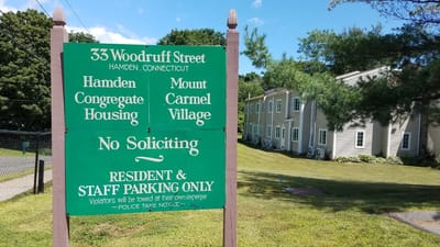 Sign for Mount Carmel Village and parking rules