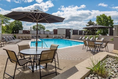 Outdoor pool area with seating and umbrellas