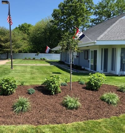 Well-maintained outdoor garden area with flags