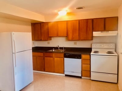 A kitchen area with appliances in a senior living facility