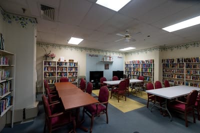 Interior view of a library with bookshelves and tables