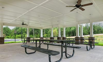 Covered outdoor seating area with picnic tables