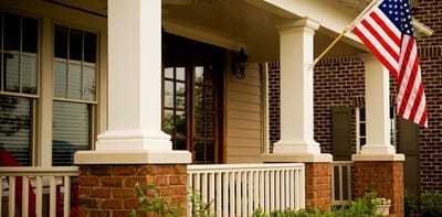 Exterior view of a welcoming porch with an American flag