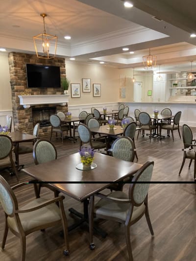 Dining area with tables and chairs set for residents