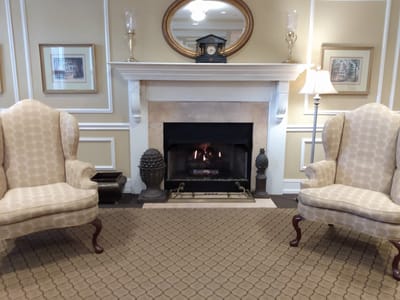 Cozy common area with armchairs and fireplace