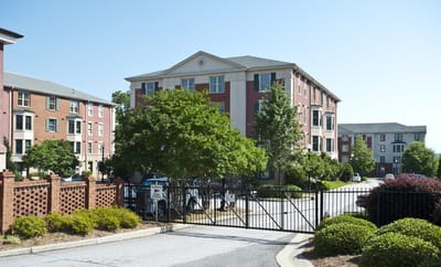 Exterior view of a senior living facility with greenery