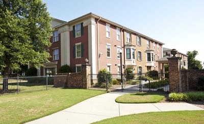 Exterior view of a senior living facility with landscaped grounds