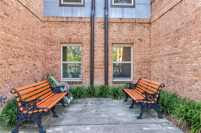 Outdoor seating area with benches and plants