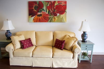 Cozy lounge area with floral artwork and lamps
