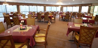 Dining area with tables and chairs in a spacious room