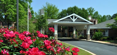 Entrance of St Mary's Highland Hills Village surrounded by flowers